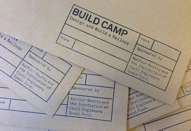 Images showing the Build Camp logo printed using a rubber stamp onto brown card